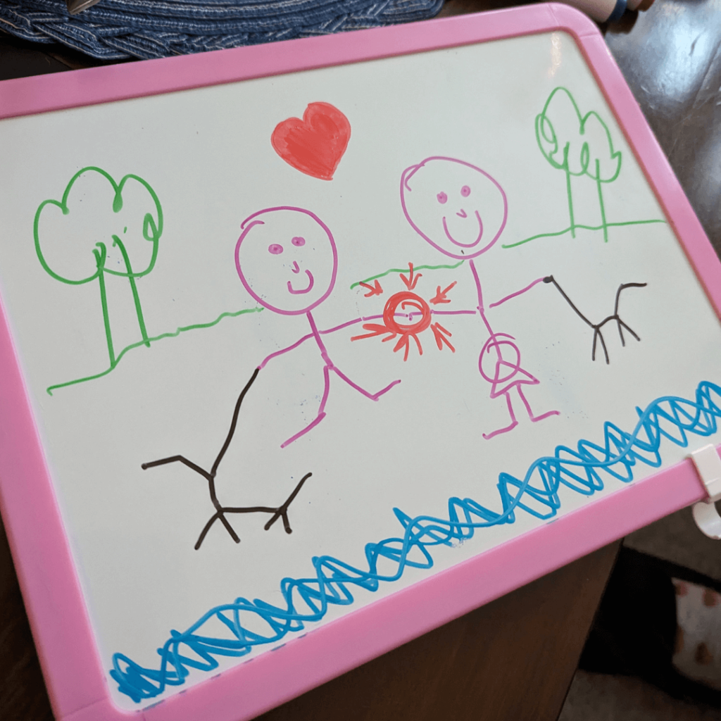 Child's drawings on a plastic white board